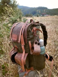 100% waxed canvas and genuine leather are used. The fabric is quite thick and, because it is waxed, it is extremely water resistant. Features Material: 100% cotton, water resistant waxed canvas and Genuine Leather Wide and deep flasks on the right and left 550 Lb parachute rope as tension straps on the flask Leather hanger for hanging knives and axes on both sides Two front pockets Axe hanger with buckle between front pockets Foam padded shoulder straps and back Hip Belt: By giving some of the weight from the shoulders to the hip bone, it prevents the shoulders from getting sore in a short time and provides a more comfortable walk.  At the top and bottom of the bag, there is a perlon hanger for hanging mats, tents, tarps, wool blankets, etc. Options : 30,40,50,60,70,80 Liters WHO WE ARE & Leather Hanger, Bushcraft Backpack, Earthy Vibes, Backpack Camping, Aesthetic Hiking, Hip Bone, Bushcraft Gear, Wool Blankets, Bushcraft Camping