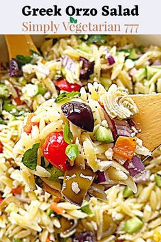 a bowl filled with pasta salad and a wooden spoon