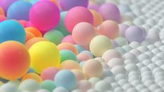 there are many different colored balls in the air on top of each other and one is white