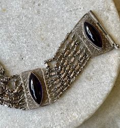 "Beautiful Silver Filigree Open Back Purple Amethyst Marquis Cabachon Vintage Bracelet The bracelet measures just under 7\" long and aprox 1 inch wide Pictures dont show color well, stone are a beautiful open back setting see matching necklace in link below https://www.etsy.com/listing/1049611046/beautiful-silver-filigree-bib-festoon?ref=shop_home_active_1&frs=1" Purple Bohemian Jewelry For Formal Occasions, Formal Bohemian Purple Jewelry, Luxury Silver Bracelets With Cabochon, Wide Pictures, Usa Jewelry, Vintage Bracelet, Handcrafted Necklace, Silver Filigree, Matching Necklaces