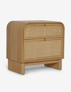 the side table with two drawers is made from wood and has a rattan finish