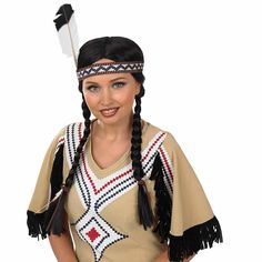 a woman in native american clothing posing for the camera