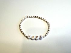 White and gold stretch bracelet that stash "hope" in alphabet letters Hope Bracelet, Gold Stretch Bracelet, L Alphabet, Alphabet Letters, Stretch Bracelet, Stretch Bracelets, Lettering Alphabet, Portland, Wedding Gifts