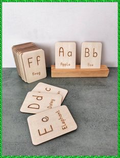 three wooden blocks with letters on them sitting next to each other