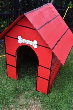 a red dog house with a bone on it