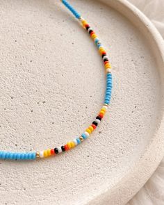 💖 Looking for the perfect Christmas gift for your girlfriend? Look no further than this multicolor boho beaded choker in blue, red, yellow, white, black & gold!  Handmade with love, this seed bead necklace in native american style is surely to impress * MATERIALS * It is made of high quality Czech seed beads This choker has adjustable stainless steel chain with lobster claw closure 📐 MEASUREMENTS * Choker thickness: 0.08 inch or 2 mm You can choose any length you need Care instructions ➖ keep Colorful Bohemian Jewelry With Letter Beads, Colorful Bohemian Letter Beads Jewelry, Bohemian Multicolor Heishi Beads Choker, Bohemian Letter Beads Choker Gift, Yellow Heishi Beads Bohemian Jewelry, Bohemian Yellow Heishi Beads Jewelry, Yellow Bohemian Heishi Beads Jewelry, Bohemian Choker Jewelry With Letter Beads, Bohemian Jewelry Choker With Letter Beads