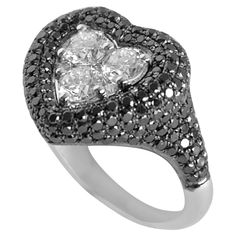 Three 0.20 carat round diamonds set in a cluster to form a heart shape in the Centre, outlining the heart shape with pave black diamonds. Available in 18k White gold. A true KAMYEN signature style, the heart pinky's have truly become synonymous with the brand. This ring should worn on the pinky or ring finger, as we don't recommend sizes above US 5. Black Diamond Solitaire Ring, Black Diamond Solitaire, Ruby Heart, Round Diamond Setting, Bracelet Love, Gio Ponti, Black Diamonds, Crown Jewels, Women Diamond