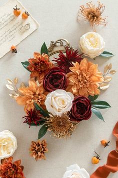 an arrangement of flowers and ribbons on a table