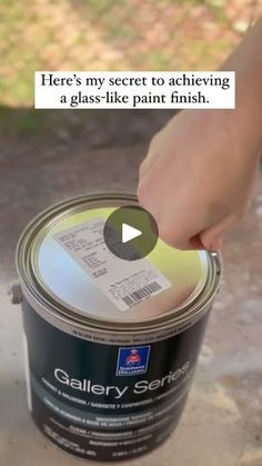 a person holding a can of paint with the caption here's my secret to achieving a glass - like patt finish