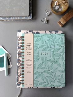 an open planner book sitting on top of a table next to other items and decorations