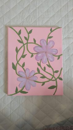 a painting of pink flowers with green leaves on a light pink square piece of paper