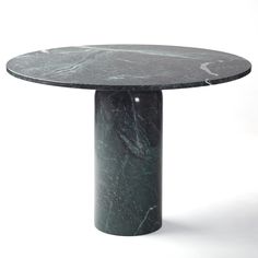 a round table with a black marble top on an isolated white background in the middle