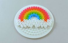 a white plate with a rainbow made out of legos on it's side