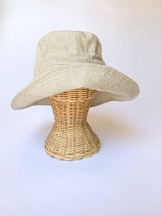 "A sun hat for beach days and summer fun. This sun hat for women has a nice wide brim to protect your whole face and even your neck and chest. A drawstring around the head keeps the hat fitting snug. Easy to bring along in your bag, folds up easy. This hat is made from a medium weight homespun linen and cotton blend fabric in a neutral beige color. Inside liner is white cotton. I used a stiff interfacing for brim to keep it's shape. Brim measures 4.5\" Crown depth is 3.5\". Contact me for custom Lightweight Sun Bucket Hat For Travel, Summer Brimmed Sun Hat One Size, Lightweight Beige Sun Hat For Vacation, Lightweight Sun Hat For Beach, Lightweight Sun Hat For Travel And Beach Season, Adjustable Wide Brim Hat For Warm Weather, Adjustable Solid Color Bucket Hat For Beach Season, Lightweight Summer Sun Hat For Vacation, Summer Brimmed Sun Hat