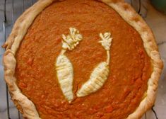 there is a pie with two carrots drawn on the top and bottom part of it