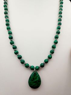 This natural Malachite Necklace is paired with small Stainless Steel spacers so you can see all the wonderful details of the stone. Please be advised not to wear this in water or it can weaken the stone.  Malachite was believed to be used in ancient Egypt as early as 3000 B.C. for jewelry and ornaments. In the Middle Ages, Malachite was used for protection of the evil eye. It opens the heart and will allow for balance on all levels. It is also associated with the element of Fire. The throat chakra governs your ability to communicate. Malachite activates this chakra to ensure that you can always speak your mind and ask for the change you need. The third eye chakra is where your deepest wisdom and powers of intuition sit. With Malachite by your side, your Third Eye is free to roam. One of it Spiritual Healing Teardrop Pendant Jewelry, Teardrop Pendant With Natural Stones For Meditation, Gemstone Teardrop Pendant Necklace For Meditation, Spiritual Gemstone Teardrop Necklace, Spiritual Teardrop Gemstone Necklaces, Teardrop Gemstone Pendant For Meditation, Spiritual Teardrop Gemstone Necklace, Teardrop Gemstone Jewelry For Meditation, Teardrop Pendant Necklace With Natural Stones For Meditation