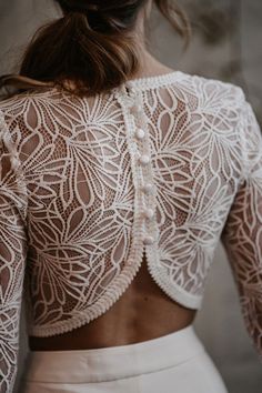 the back of a woman's white lacy top