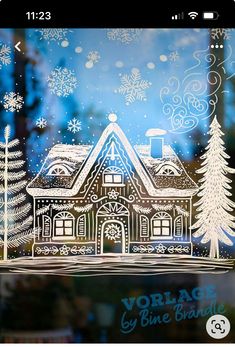 an image of a house in the window with snowflakes and trees on it