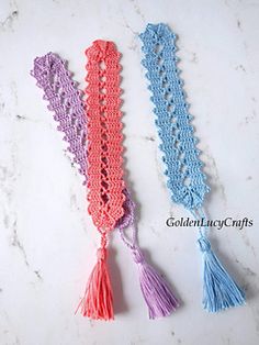 three crocheted tassels on a marble surface