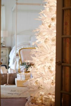 a white christmas tree in a living room