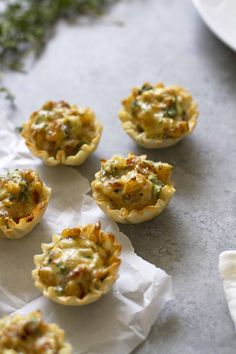 mini quiche cups with cheese and herbs on the side, ready to be eaten