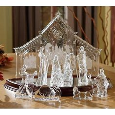 a glass nativity scene on a wooden table