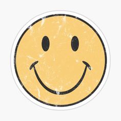 a yellow smiley face sticker on a white background