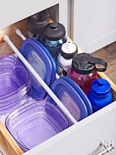 the drawers are filled with plastic containers and lids for drinks or water to be placed in