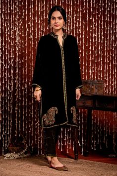 Black jacket style kurta with paisley, sequin, thread embroidery on hem. Paired with striped pant.
Component: 2
Pattern: Embroidery
Type Of Work: Paisley, sequin, thread, stripe
Neckline: Mandarin collar
Sleeve Type: Full sleeves
Fabric: Kurta: Silk Velvet, Pant: Stripe Tissue 
Color: Black
Other Details: 
Striped pant
Front open kurta
Occasion: Sangeet - Aza Fashions Front Open Kurti Designs, Black Jacket Style, Embroidery Paisley, Velvet Pant, Embroidery Fashion Detail, Velvet Dress Designs, Striped Pant, Pakistani Fashion Party Wear, Kurta Designs Women