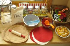 the table is set with dishes, cups and utensils for children to eat