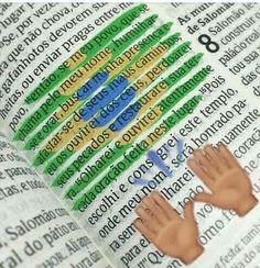 two hands on top of an open book with the word love spelled in green and yellow