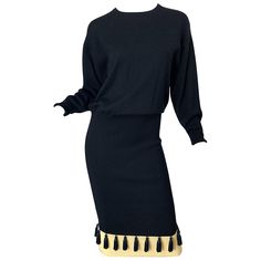 Chic vintage 80s ANGELO TARLAZZI black and ivory dolman sleeve sweater dress ! Features a luxurious soft wool that feels like cashmere. Black tassels line the hem of the dress. Simply slips over the head and stretches to fit. Slouchy fit with a drop waist that you can pull up. The perfect little black dress with so much attention to details. In great condition Made in Italy Marked Size 38 Measurements: ( lots of stretch ) 40-44 inch bust ( dolman sleeve ) 34-38 inch waist 32-40 inch hips 51 inches from top back shoulder seam to hem Angelo Tarlazzi, 80s Sweater, Dolman Sleeve Sweater, Designer Evening Dresses, Perfect Little Black Dress, Couture Vintage, Vestidos Vintage, Chic Vintage, Soft Wool