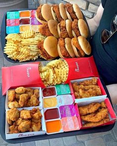 two trays filled with different types of food next to each other on a table