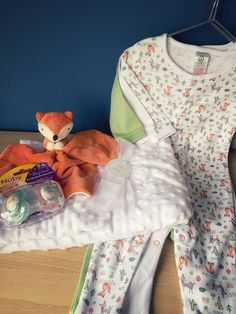 the baby's clothes are laid out and ready to be put into the crib