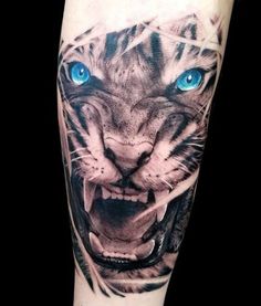 a white tiger with blue eyes on the arm is shown in black and grey ink