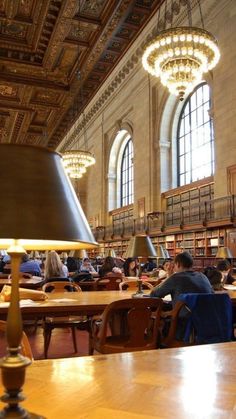 people are sitting at tables in the library