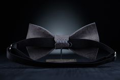 "Stylish and fashionable accessory is great for so many occasions! Our bow ties are made with love from 100% Full Grain Leather, with adjustable neck strap. The mission of this accessory is to raise the mood and self-confidence of its owner, to give a sense of style! Material: 100% Full Grain Leather Color: Stone Gray Design: minimalist Style: unisex Size ADULT): - 6x11 cm. (2.3x4.3\") - strap is regulated; - the width of strap is 1.5 cm. (3/4\"). Size YOUTH): - 5x8 cm. (1.9x3.1\") - strap is re Dapper Ties As Gifts, Dapper Standard Ties For Gift, Dapper Standard Ties As Gifts, Classic Bow Tie For Suit Accessories As Gift, Adjustable Satin Bow For Gifts, Black Bow Tie For Wedding, Adjustable Suit And Tie Accessories For Father's Day Gift, Silver Ties For Father's Day Gift, Elegant Silver Bow Tie For Gift