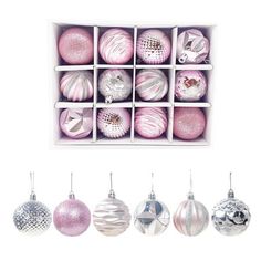 twelve pink and white christmas ornaments in a box with silver glittered baubles