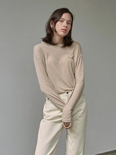 Soft and drapery, this relaxed fit t-shirt features minimalistic silhouette. Wear yours alone, or layer with any items throughout the seasons.  - Intended for a loose fit- Basic crewneck and long sleeves- Natural dropped shoulders- High-low rounded hem - Versatile styling with various items Beige Long Sleeve T-shirt For Everyday, Neutral Crew Neck Top For Layering, Relaxed Beige Top For Layering, Simple Beige Top For Everyday, Neutral Long Sleeve Tops For Everyday, Everyday Neutral Long Sleeve Tops, Simple Everyday Beige Top, Relaxed Beige Crew Neck Top, Relaxed Fit Neutral Tops For Layering