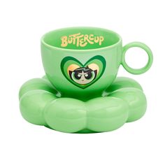 a green coffee cup sitting on top of an inflatable object with the word buttercup printed on it