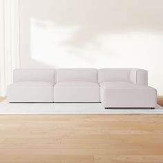 a white couch sitting on top of a hard wood floor