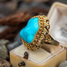 This incredible turquoise cocktail ring is crafted of 14k yellow gold and features stunning detailing. The ring is currently a size 6. Turquoise Cocktail, October Birth Stone, The Ring, Cocktail Ring, High Quality Jewelry, Cocktail Rings, Estate Jewelry, Ring Size, Wedding Rings