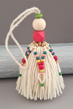 a white tasseled bag with colorful beads on it