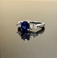 "DeKara Designs Collection Beautiful Modern/Art Deco Ceylon Blue Sapphire and Diamond Ring Metal- 90% Platinum, 10% Iridium Stones- Natural Oval Ceylon Blue Sapphire 1.34 Carats, 2 Trillion Cut Diamonds, F-G Color VS1 Clarity, 0.52 Carats. Size-6 1/4 Plus. FREE SIZING Classic and Timeless Art Deco Inspired Ceylon Blue Sapphire Oval Diamond Engagement Ring. The center sapphire is a beautiful deep blue in color, and is \"Eagle Claw\" prong set to perfection, with two Trillion Cut Diamonds that are Gia Certified Heart Cut Wedding Ring, Three Stone Lab-created Sapphire Diamond Ring, Blue Three Stone Platinum Jewelry, Three Stone Sapphire Round Ring Fine Jewelry, Sapphire Three Stone Round Cut Diamond Ring, Three Stone Sapphire Diamond Ring With Round Cut, Classic Sapphire Diamond Promise Ring, Classic Trillion Cut Sapphire Ring, Classic Sapphire Marquise Cut Ring