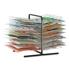 a stack of magazines sitting on top of a metal stand