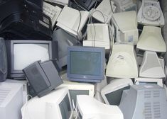 there are many old computers and televisions piled up together on the floor in this pile