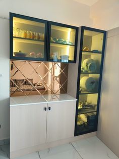 a kitchen area with cabinets and shelves filled with dishes