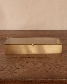 a gold box sitting on top of a wooden table