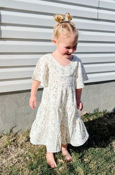 Introducing the Briggs Dress - the ultimate dreamy, flowy, and fabulous addition to your little's wardrobe! With its midi length, flowy sleeves, and v neckline, this dress is perfect for twirling around. But wait, there's more! The Briggs Dress also features a stunning floral pattern and tiered skirt detail, making it the perfect little girls dress. Dont forget to grab the adult version and match with your mini! *Relaxed fit* Material Content: Self: 100% Polyester // Lining: 100% Rayon Material White Spring Twirl Dress With Short Sleeves, Flowy Spring Twirl Dress With Flutter Sleeves, Spring Twirl Dress With Short Sleeves, Spring Short Sleeve Flowy Twirl Dress, Flowy Short Sleeve Twirl Dress For Spring, White Flutter Sleeve Twirl Dress With Ruffles, White Twirl Dress With Ruffles And Flutter Sleeves, White Flutter Sleeve Twirl Dress For Spring, White Flutter Sleeve Twirl Dress For Summer