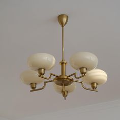 a chandelier hanging from the ceiling with five lights on each side and one light in the middle